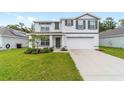 Charming two-story home featuring a well-manicured lawn and an attached two-car garage at 11205 Se 69Th Ter, Belleview, FL 34420