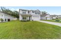 Charming two-story home featuring a well-manicured lawn and an attached two-car garage at 11205 Se 69Th Ter, Belleview, FL 34420