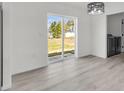 Bright dining room with a sliding glass door that opens to the backyard and a laundry room at 11506 Nw 20Th St, Ocala, FL 34482