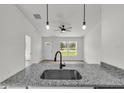Open-concept kitchen featuring granite countertops, stainless steel sink, and views into the living area at 11506 Nw 20Th St, Ocala, FL 34482
