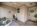 Inviting lanai featuring a ceiling fan, tile flooring, neutral color scheme, and cozy seating area at 1405 Espinoza Ln, Lady Lake, FL 32159