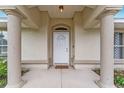 Inviting front entrance with decorative columns, and a charming white door with glass window at 14650 Sw 33Rd Ln, Ocala, FL 34481