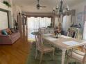 Well-lit dining room features hardwood floors, chandelier, and comfortable seating at 1815 Puerto Bello Dr, The Villages, FL 32159