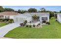 Inviting single-story home boasts a well-kept lawn and beautifully designed landscaping at 1819 Captiva Ct, The Villages, FL 32162
