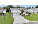 Lovely single-story home showcases a manicured lawn and thoughtfully arranged landscaping at 1819 Captiva Ct, The Villages, FL 32162