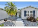 Cozy front porch with seating area, complemented by neat landscaping and inviting entrance at 1819 Captiva Ct, The Villages, FL 32162