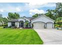 Charming one-story home features a well-manicured lawn, inviting entryway, and three-car garage at 19115 Sw 98Th Loop, Dunnellon, FL 34432