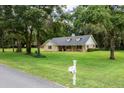 Charming single-story home with dormer windows, nestled among mature trees at 26 Count Fleet Dr, Ocala, FL 34482