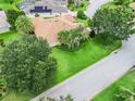 The home shows mature landscaping surrounding this pristine property at 2721 Day Lily Run, The Villages, FL 32162