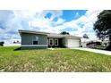 Picture of a one-story home with a well-maintained lawn and a two-car garage at 2883 Sw 146Th Place Rd, Ocala, FL 34473