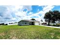 A charming single-Gathering home boasting lush greenery and a spacious, well-maintained lawn at 2883 Sw 146Th Place Rd, Ocala, FL 34473