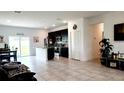Open-concept living space with tile flooring seamlessly connecting the living, dining, and kitchen areas at 2883 Sw 146Th Place Rd, Ocala, FL 34473
