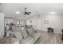 Open-concept living area with light wood floors connecting to the kitchen island at 42 Almond Dr, Ocala, FL 34472