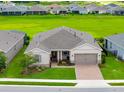 Aerial view of a well-maintained single Gathering home with lush green surroundings in a quiet, residential neighborhood at 4419 Nw 54Th Ter, Ocala, FL 34482