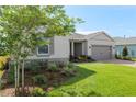 Single Gathering home featuring manicured lawn, mulched flower beds, and an inviting entrance with decorative columns at 4419 Nw 54Th Ter, Ocala, FL 34482