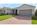 A well-maintained one story single Gathering home with a brick paver driveway, and lush landscaping at 4419 Nw 54Th Ter, Ocala, FL 34482