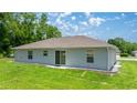 View of backyard featuring green lawn, simple landscaping, and siding exterior at 458 Marion Oaks Trail Trl, Ocala, FL 34473