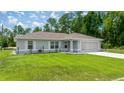 Inviting single-story home with a well-kept lawn and attached garage at 458 Marion Oaks Trail Trl, Ocala, FL 34473