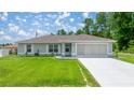 Charming single-story home with well-manicured lawn and two-car garage at 458 Marion Oaks Trail Trl, Ocala, FL 34473