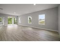 Open living area with sliding glass doors and multiple windows providing abundant natural light at 5 Larch Course Ter, Ocala, FL 34480
