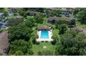 Aerial shot of a community pool surrounded by mature trees and landscaping at 505 Fairways Ln # B, Ocala, FL 34472