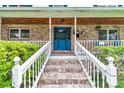 Inviting front porch with brick accents, stylish tiling, and a bright blue front door, perfect for relaxation at 510 Se 19Th St, Ocala, FL 34471