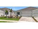 Attractive home with a two-car garage, brick driveway, and well-maintained landscaping at 5233 Nw 43Rd Lane Rd, Ocala, FL 34482