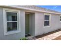 Charming home exterior showcases large windows and inviting entry door at 5233 Nw 43Rd Lane Rd, Ocala, FL 34482