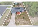 Aerial view of single-story home with private pool, patio, solar panels, and large driveway at 603 Marion Oaks Blvd, Ocala, FL 34473