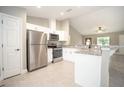 Modern kitchen featuring stainless steel appliances, granite countertops, white cabinets, and an open layout at 8937 Se Highway 42, Summerfield, FL 34491