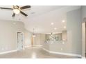 Bright, open-concept living area with tile floors, ceiling fan, and a breakfast bar overlooking additional living spaces at 8937 Se Highway 42, Summerfield, FL 34491