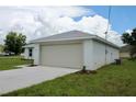 A cozy home featuring an attached two-car garage, clean stucco exterior, and a manicured lawn at 9 Hemlock Terrace Ln, Ocala, FL 34472