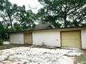 View of a one story home with a detached garage; the house features neutral siding and light colored trim at 25600 Se 152Nd Pl, Umatilla, FL 32784