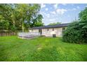 Spacious backyard featuring a well-maintained lawn and a white wooden deck, perfect for outdoor entertaining at 6021 Nw 54Th Ter, Ocala, FL 34482