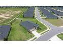Aerial view of the house in a neighborhood showcasing the roof, lawn, and surrounding homes at 7828 Sw 74Th Loop, Ocala, FL 34481