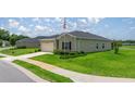 Well-maintained single-story home with green grass, and a neatly paved driveway at 7828 Sw 74Th Loop, Ocala, FL 34481