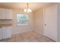 Cozy eat-in kitchen with white cabinetry and tile flooring, bathed in natural light at 956 Osceola Trl, Casselberry, FL 32707