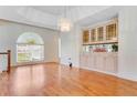 Bright dining room featuring hardwood floors and built-in hutch at 3082 Landings Ct, Haines City, FL 33844