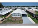 Aerial view of the property showcasing its well-maintained lawn, carport, and established landscaping in a vibrant community at 6739 Kensington Ne Dr, Winter Haven, FL 33881