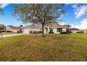 House with a large front yard, showcasing a single-story home at 1518 Blue Sky Blvd, Haines City, FL 33844