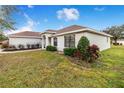 A light-colored house with a neatly landscaped front yard at 1518 Blue Sky Blvd, Haines City, FL 33844