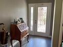 Foyer featuring tile floors, decorative entry door, and a decorative wooden secretary at 416 Sandestin Dr, Winter Haven, FL 33884