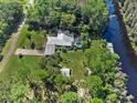 Expansive property with a pool, dock, and lush greenery, creating a private retreat by the water at 6168 Arborea Dr, Lake Wales, FL 33898
