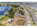 Expansive aerial view showcasing a lakeside home with solar panels and nearby community at 1396 Lucerne Loop Ne Rd, Winter Haven, FL 33881