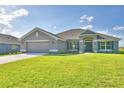 Two-story house with a gray exterior and green lawn at 4081 Tullamore Ln, Auburndale, FL 33823