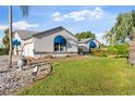 Well-maintained home featuring manicured landscaping and charming blue awnings over the windows for added curb appeal at 5660 Sandpipers Dr, Lakeland, FL 33809