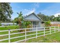Charming light blue house with white picket fence and lush landscaping at 954 Reynolds Rd, Lakeland, FL 33801