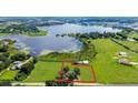 Aerial view showing a house on a large lot near a lake at 420 W Gates Ave, Lake Hamilton, FL 33851