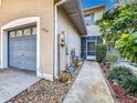 Front entry with walkway, landscaping, and attached garage at 2310 Isle Royale Se Ct, Winter Haven, FL 33880