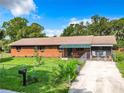 Ranch style home with green awning and fenced yard at 4346 Chambers St, Lake Wales, FL 33898